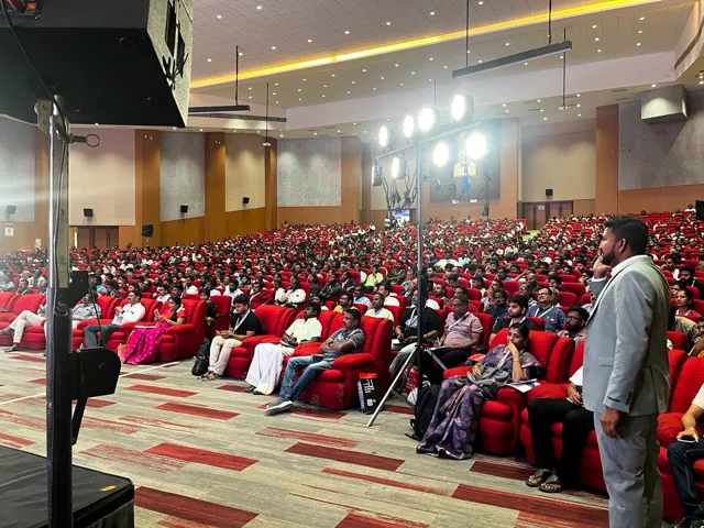 A packed auditorium at a trading event